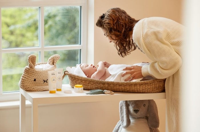 mother changing baby's nappy