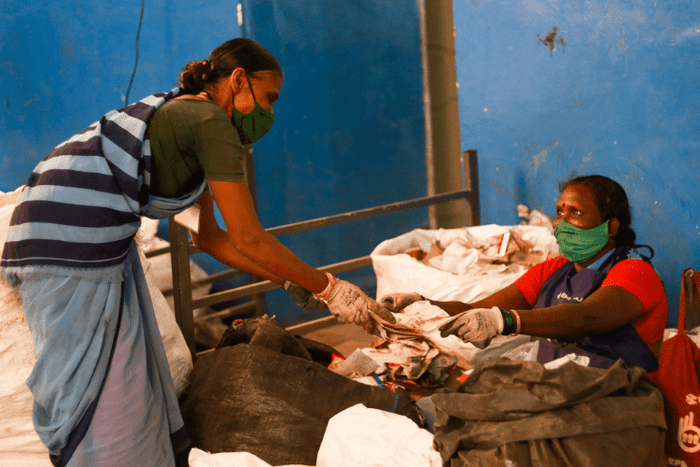 female workers collecting and sorting plastic waste
