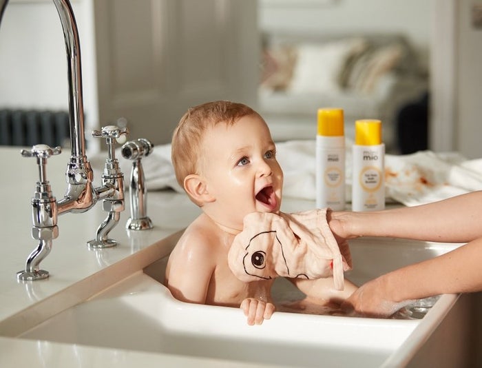 baby being washed in sink