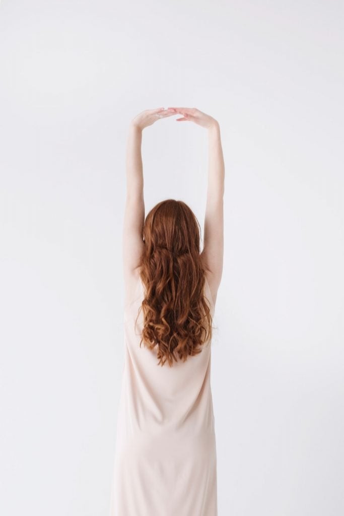 Woman waking up and stretching