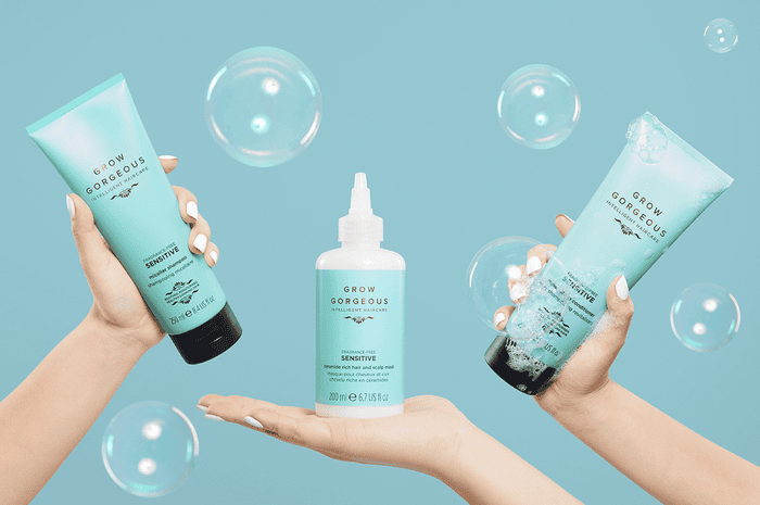 3 Grow Gorgeous sensitive products held in different hands with bubbles and a blue background