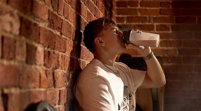 man drinking a protein shake