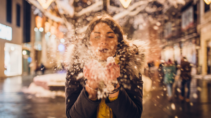 woman blowing snow in air