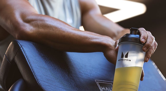 man holding protein shake