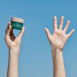 Hand holding face cream