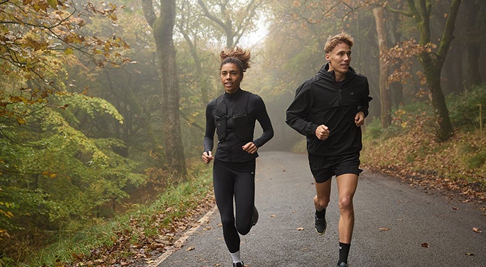 man and woman running in nature