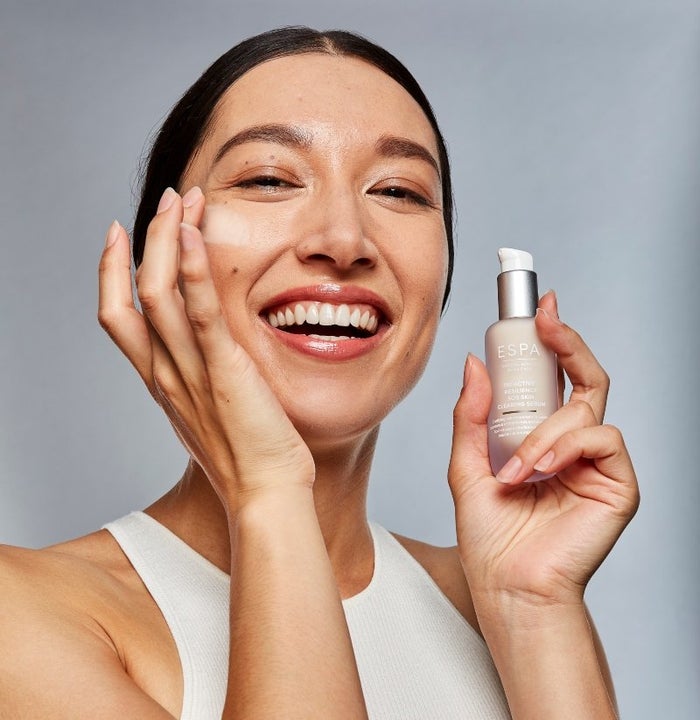 woman trying ESPA skincare serum