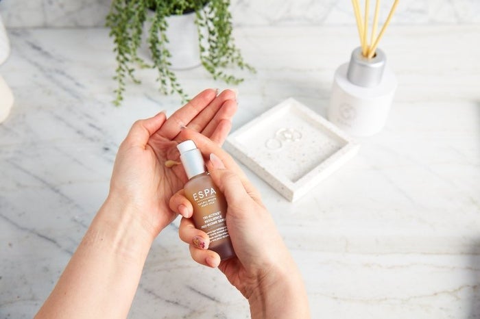 woman applying ESPA biome serum