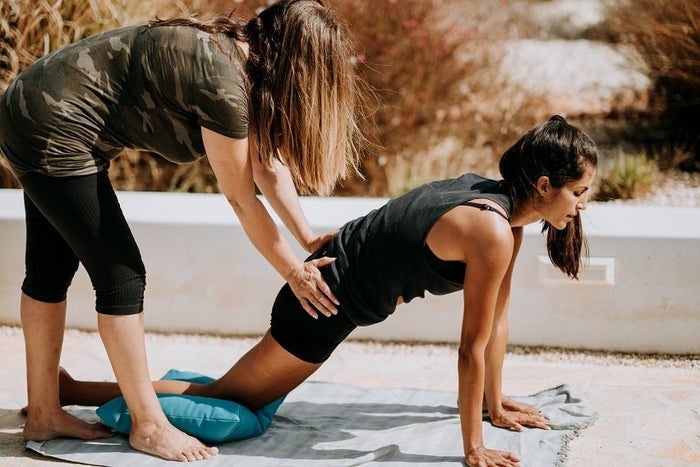 Woman PT correcting alignment of client