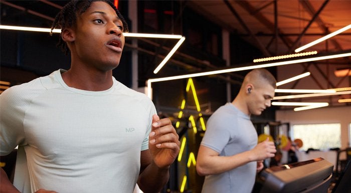 two men running on treadmills