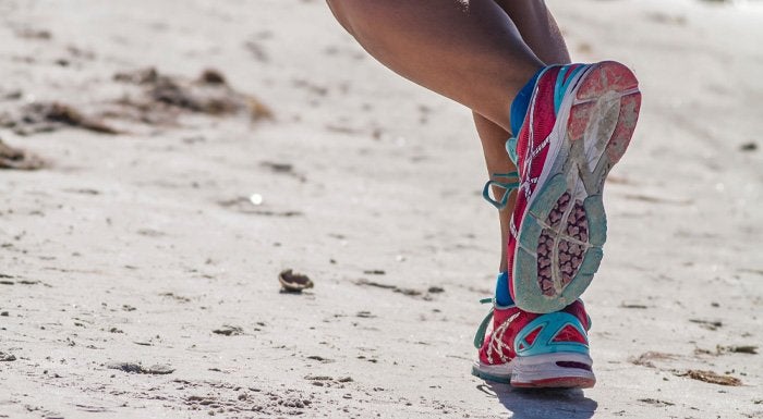 women running on the beach in trainers