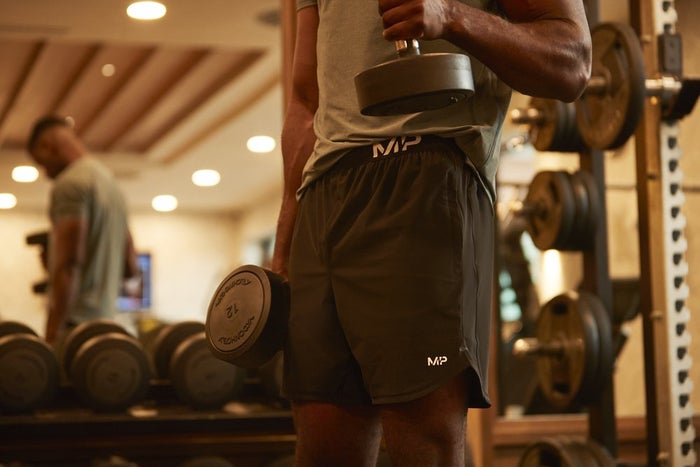 New boxing training clothing from Myprotein, featuring a man lifting dumbbells.