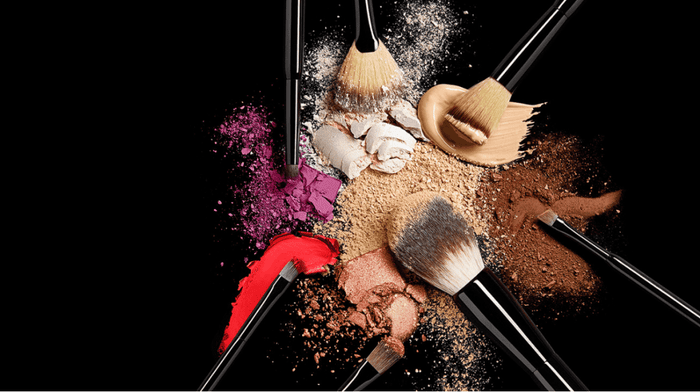 Makeup brushes surrounded in powder product