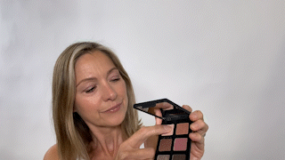 woman applying pink eyeshadow