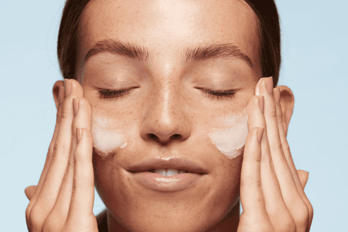 Woman applying face mask