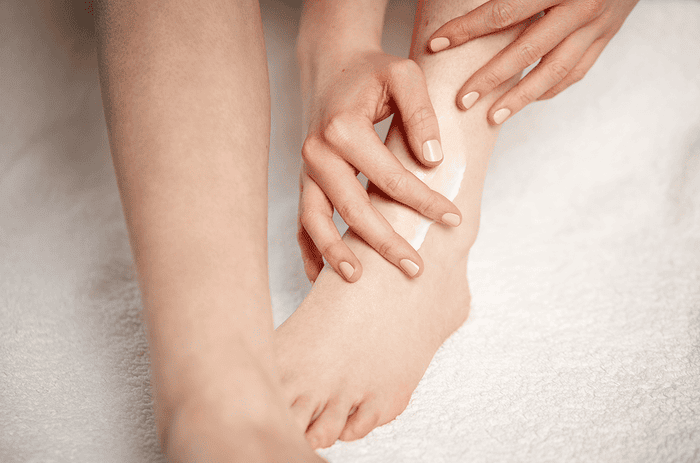 woman applying foot cream