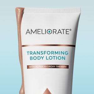 A product shot of Illuminating Glow Transforming Body Lotion against a blue gradient background. The lotion is dripping down the side of the bottle.