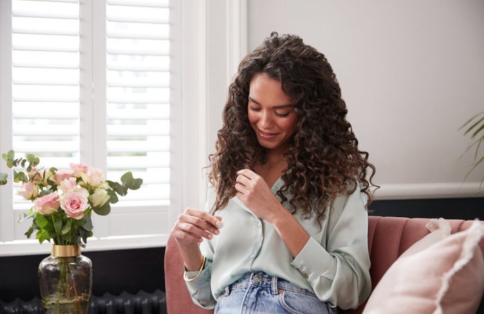 woman looking at ends of hair