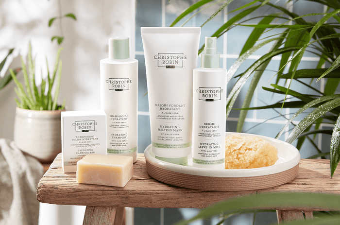 Four professional products by Christophe Robin's Hydrating range. White bottles and a white box with olive green accents.