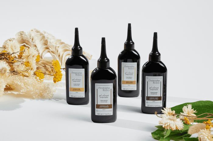Four luxury products by Christophe Robin's temporary colour gel range. Black bottles with colours shown on bottles.