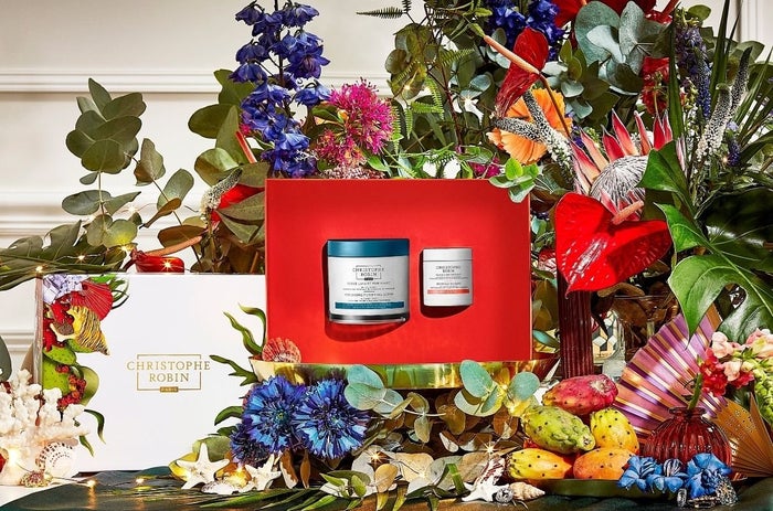 Christmas gifts for beauty lovers containing two iconic Christophe Robin scrub and mask products surrounded by colourful flowers.