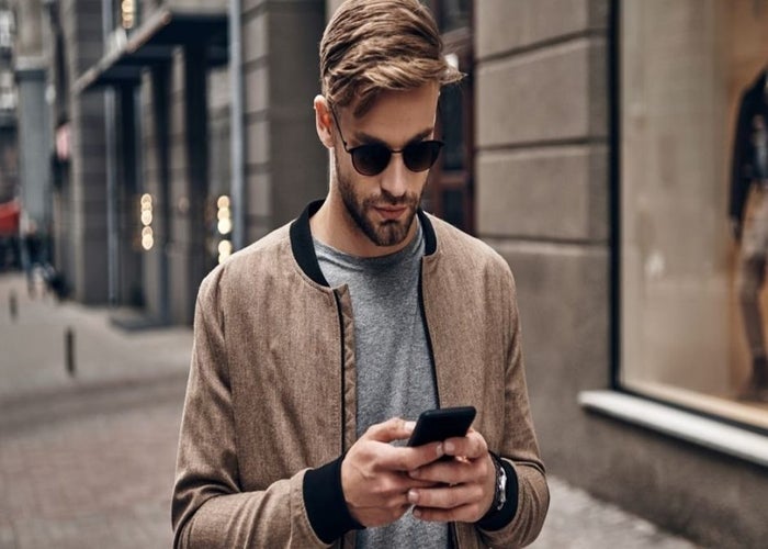 young, stylish man wearing a casual jacket over a t-shirt