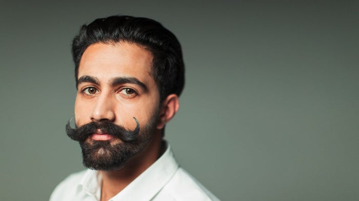 Young man in a white shirt with a perfectly styled handlebar moustache | Gillette UK