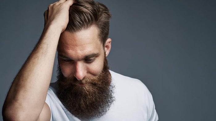 man with a faux hawk haircut to hide a receding hairline