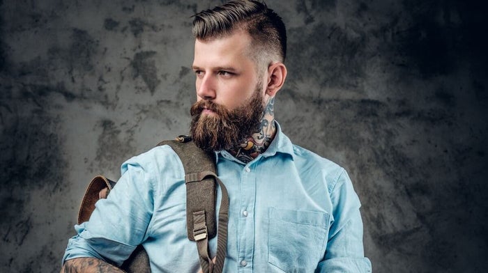 smart-looking, bearded man with tattoos