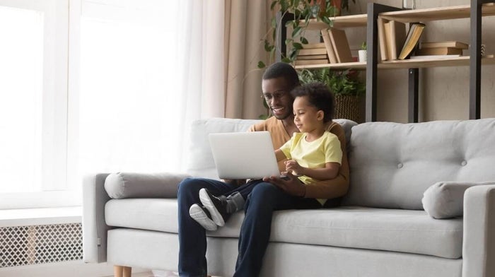 father and son enjoying sofa tourism