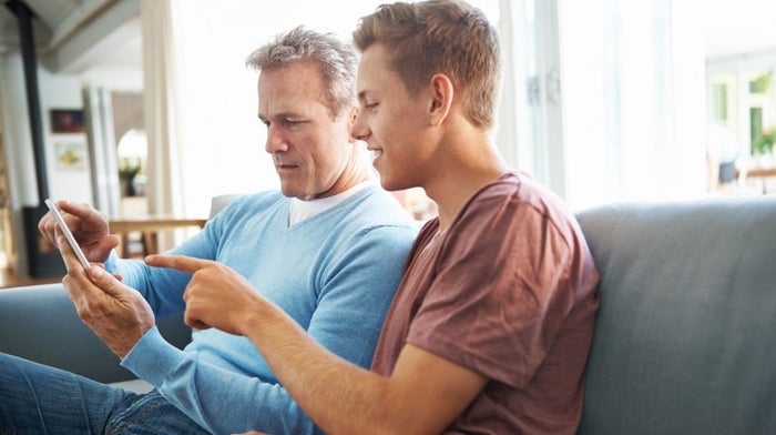 father and son talking on the sofa