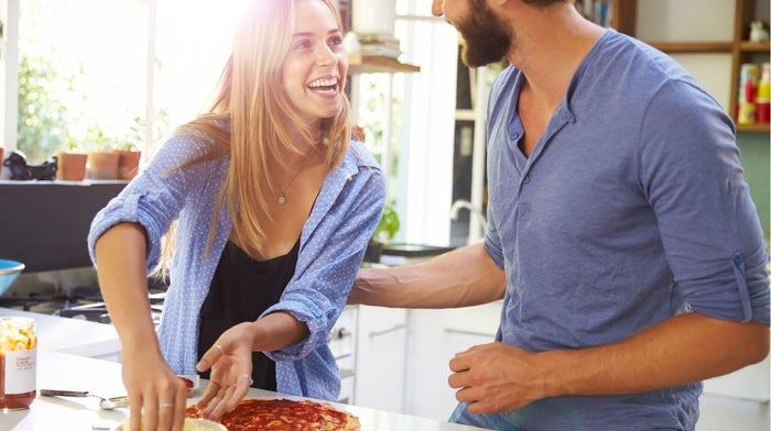couple making pizza together