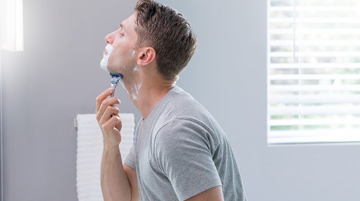man shaving with a Gillette razor