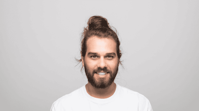 Smiling man with topknot and professional long beard style