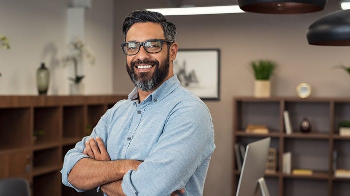 A man with a beard smiles after receiving a shaving kit gift set | Gillette UK