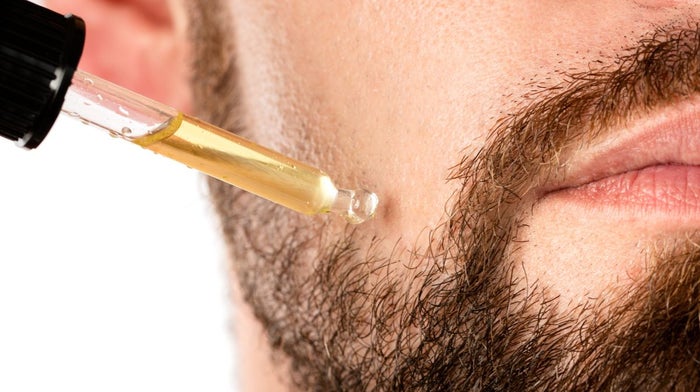 Male face and pipette with a oil for a beard growth | Gillette UK