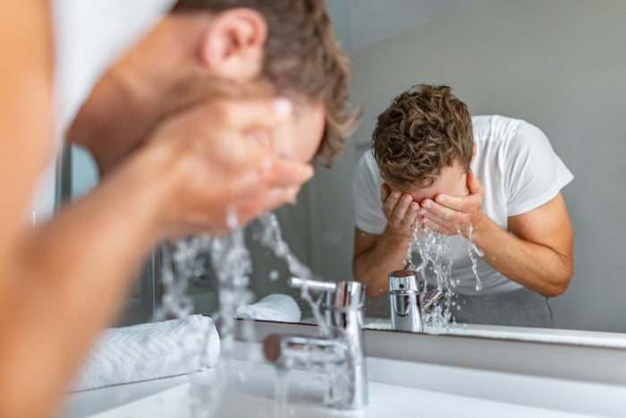 A man with a beard washes his face | Gillette UK