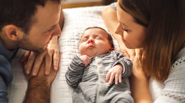 A new dad looks at his newborn baby with his partner on Father’s Day | Gillette UK