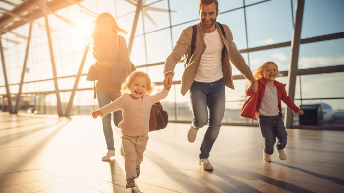 A dad who was gifted a Gillette shaving kit plays with his daughters at an airport | Gillette UK