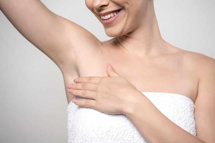 Smiling woman after shaving her underarm with Venus Extra Smooth Snap Razor