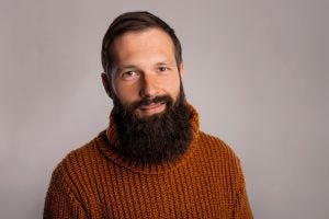 A man with a Viking beard wearing an orange jumper | Gillette UK