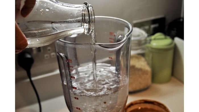 pouring water into blender