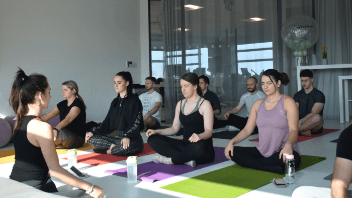 group sitting in yoga position