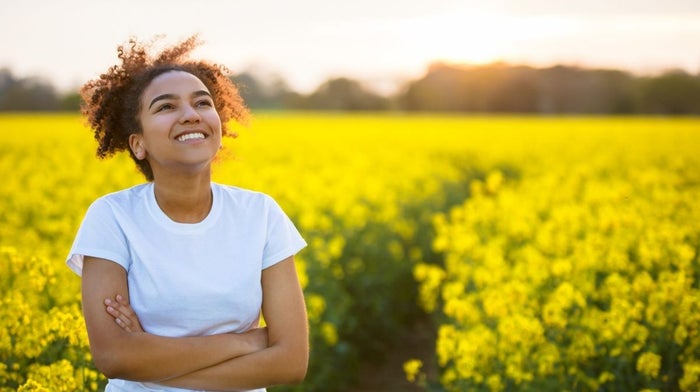 woman relaxing in a field of yellow flowers