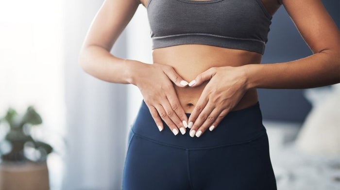 woman with hands on stomach