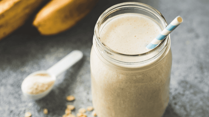 vanilla kefir smoothie in glass jar with straw