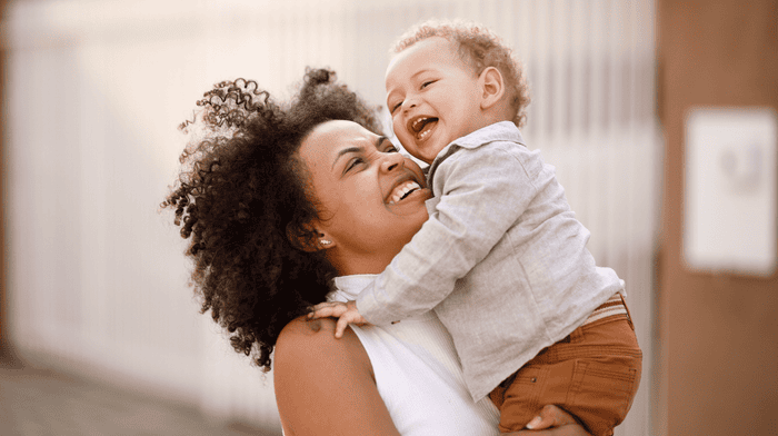 mother holding happy baby