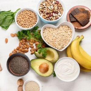 An assortment of gut-friendly food, including grains, nuts, avocados, fruit and yogurt.