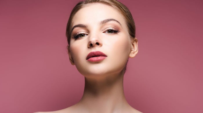 A young woman with her completed soft glam makeup look.