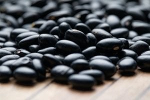 Black Raw Beans on a wooden table